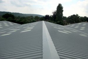 view of new corrugated metal roofs on industrial buildings in Sussex completed by Kingsley Roofing